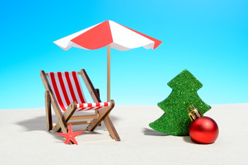 Merry Christmas on beach concept. Lounge chair with umbrella and Xmas decorations
