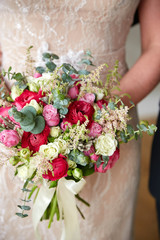 The bride is holding her bouquet of flowers