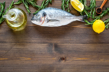 Fresh dorado fish ready to cook on wooden background top view copyspave