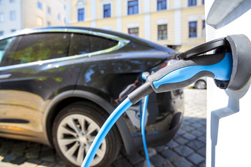 Close up of the power supply plugged into an electric car being charged