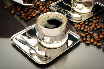 Coffee cup with delicious roasted beans in luxurious coffee set.