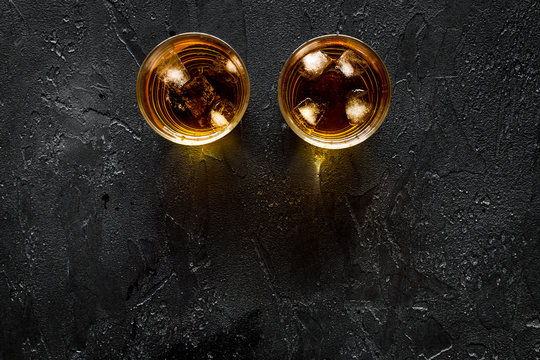 Alcohol cocktails with whiskey and ice black bar background top view mockup