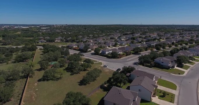 A day high angle aerial establishing shot of a typical San Antonio, Texas residential neighborhood.  	