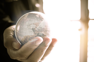Businessman holding Earth globe model ball map with Radar background in hands. Concept for global...