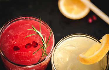 Pomegranate and orange cocktails with ice, top view