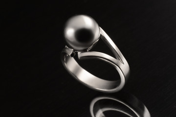 ring  in white gold and silver on black background