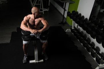 Fototapeta na wymiar Chest Exercise With Dumbbells In A Gym