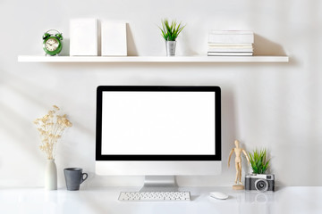 Loft studio concept. Designer work space blank screen desktop computer, vintage toy, houseplant and...