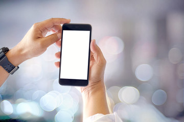 Mockup smartphone blank screen in man hands over blurred background.