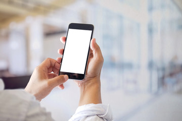 Mockup smartphone blank screen in man hands in blurred office interia background.