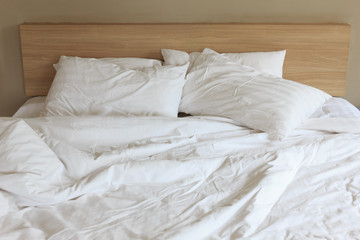 Fototapeta na wymiar Messy white bed on the morning time.