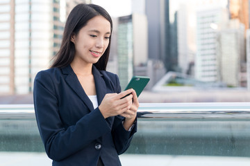 Business woman using mobile phone in the city