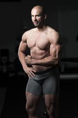 Fototapeta na wymiar Man in Gym Showing His Well Trained Body