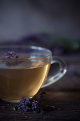 Green tea with herbals. Tea with oregano on the wooden background