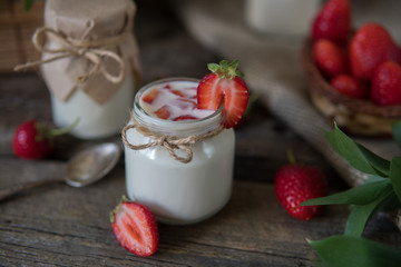 Organic yougurt in jar with strawberry. Fresh strawberry with yogurt