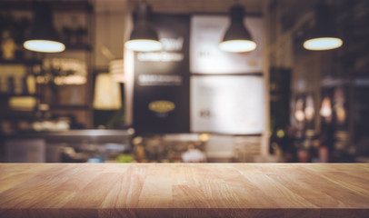 Wood table top on blurred of counter cafe shop with light bulb background.For montage product display or design key visual - obrazy, fototapety, plakaty