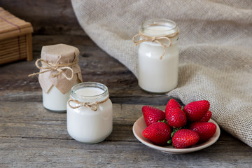 Obraz na płótnie Canvas Organic yougurt in jar with strawberry. Fresh strawberry with yogurt