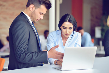 Teamwork process concept.Young coworkers work with new startup project in office.Analyze document, plans.