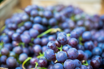 Grape in the wooden crate. Shallow depth of field.