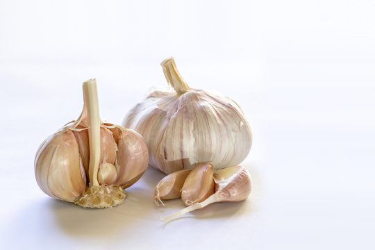 Garlic bulbs and cloves closeup on white background