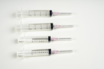 insulin and large syringe, white background.