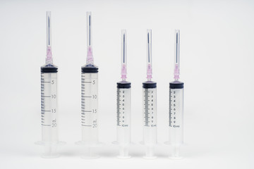 insulin and large syringe, white background.