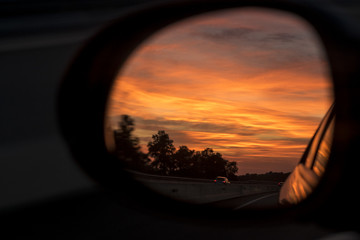 Red dusk cloudscape on a mirror car