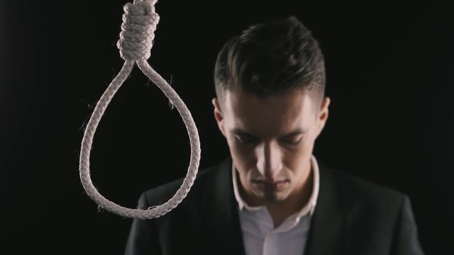 suicide. unhappy businessman wants to commit suicide. The loss of money, the collapse of business or bankruptcy.