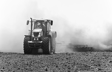tractor working in the field. Tractor plow field Agriculture.