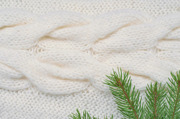 Christmas background white knitting pattern and spruce branches