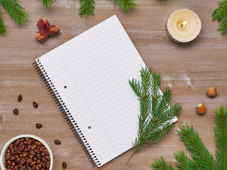 Christmas song from the notebook, fir branches, candles burning hazelnuts and pine nuts on the old Board
