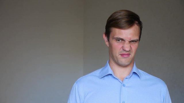 4k. Slow motion. Close up portrait of a young man. body language and gestures. he is disgusted.