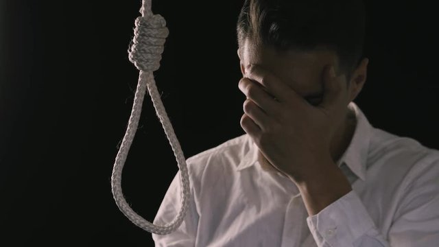 unhappy businessman wants to commit suicide. The loss of money, the collapse of business or bankruptcy.