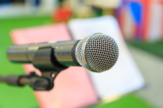Microphone on microphone stand and note stand background.