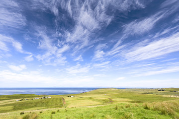 Obraz premium Rural landscape on a sunny day in Linicro on the Isle of Skye in Scotland.