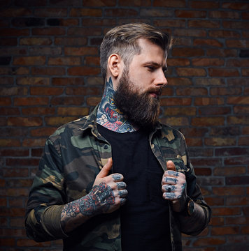 Tattooed bearded male in military jacket.