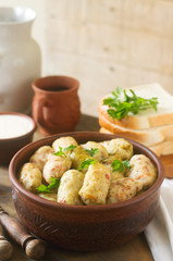 Cabbage rolls served with sour cream, bread and wine. Dolma, sarma, sarmale, golubtsy or golabki.