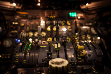 Control levers in airplane cockpit closeup with selective focus.