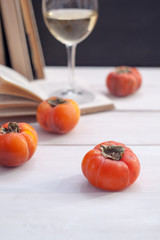  Still life with concept of spending autumn time at cozy home weekend still life. Book, glass of wine and fruits, selective focus, vertical photo