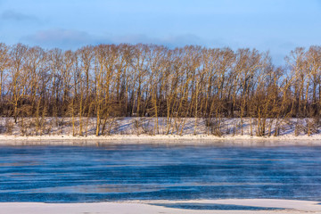 Forest edge on the bank of the frozen Volga river. Winter Russia, Uglich.
