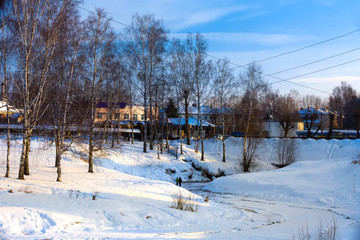 Fototapeta na wymiar Children walk on thin ice on the river. Winter Russia, Uglich.