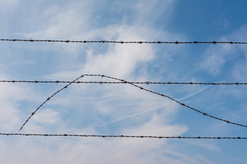 Barbed Wire in the sky with clouds