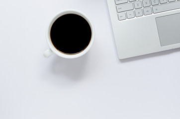 Obraz na płótnie Canvas Laptop and black coffee on white background with copy space.