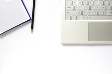 Laptop and note book and pencil on white background.