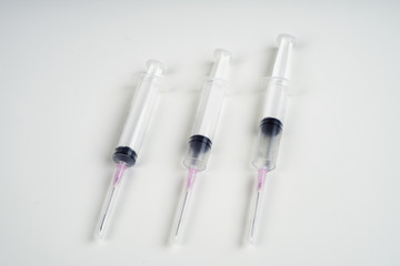 insulin and large syringe, white background