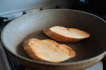  Pieces of fried bread in a frying pan. Place for text.