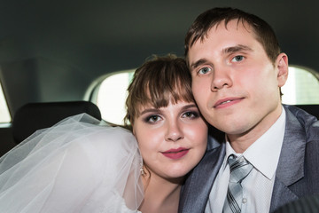 Bride and groom in a car in a wedding