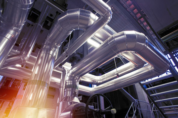 Equipment, cables and piping as found inside of a modern industrial power plant