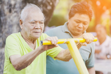 elderly exercise on park. Seniors doing exercises concept. Medical Assistant take care Elderly patients the exercise,