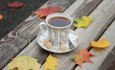 Autumn leaves and a hot cup of tea.